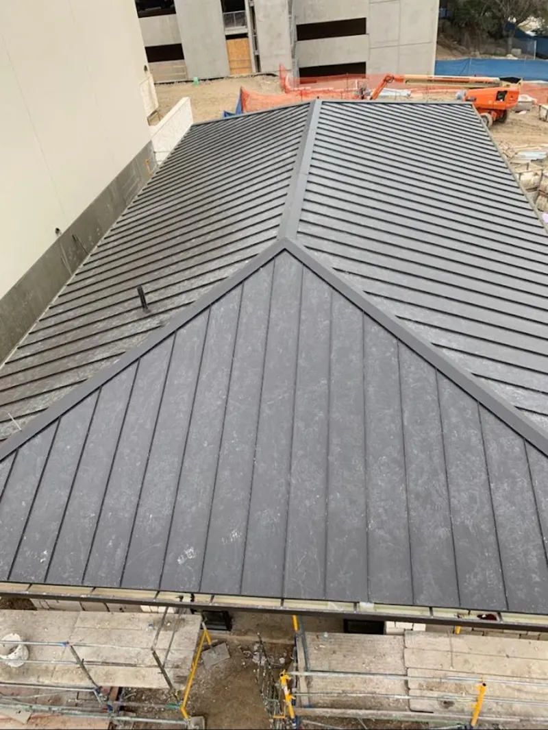 Commercial metal roof construction with crane equipment in Moultrie