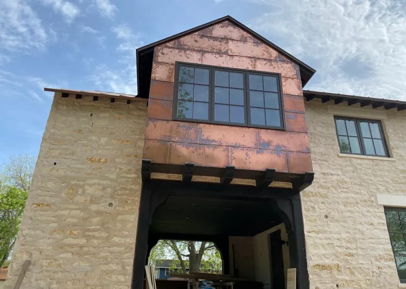 Copper metal panel facade on a stone building for Metal Roof Coating in Moultrie